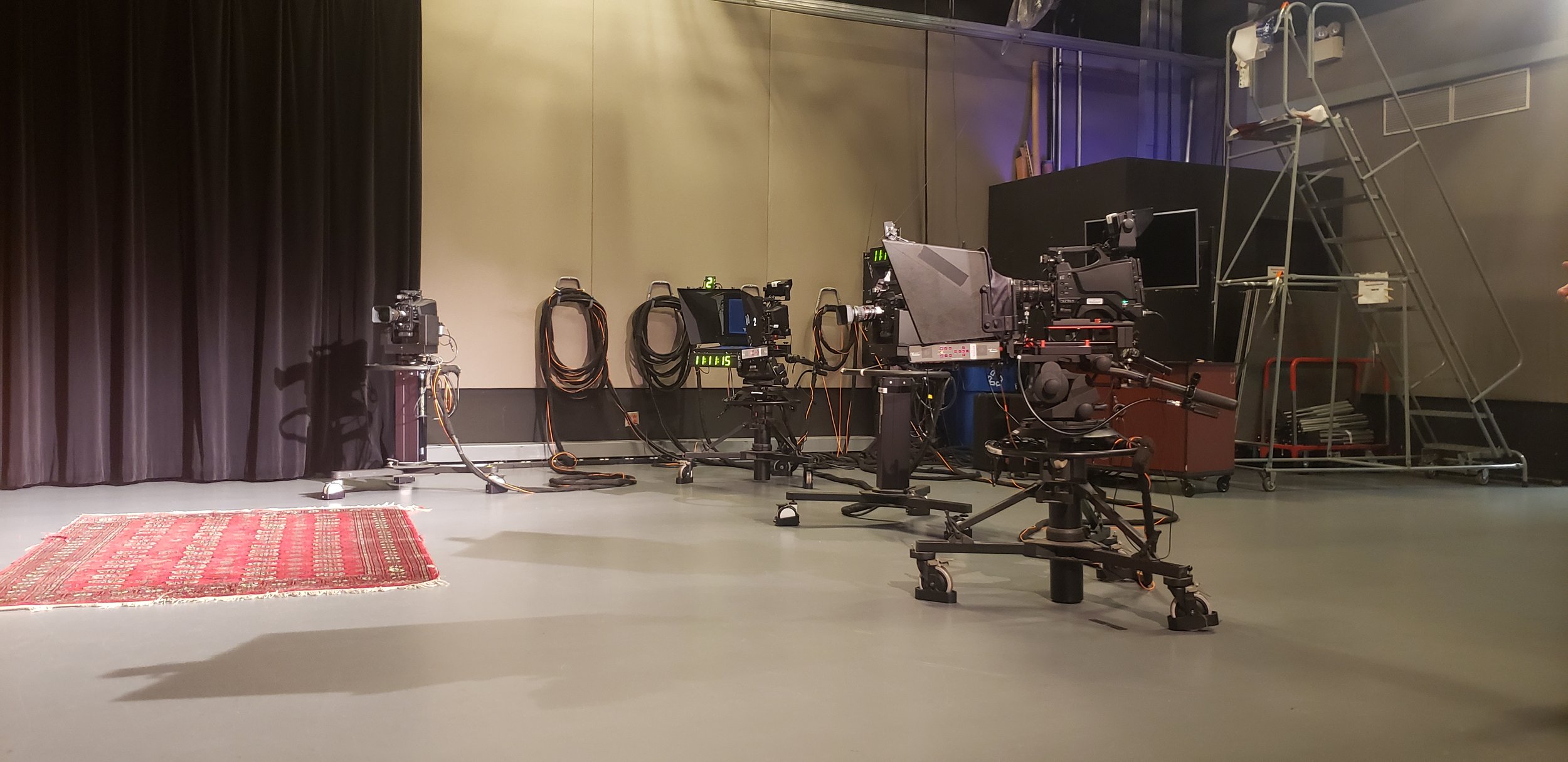 Cameras arranged in a professional TV studio.