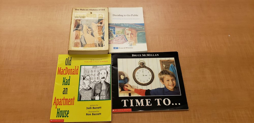 Four source books arranged in a square. The top two books (left to right)  The Pelican History of Art  and  Deciding to Go Public . The Bottom two (left to right)  Old MacDonald Had an Apartment  and  Time too…  The books are all on a wooden table.