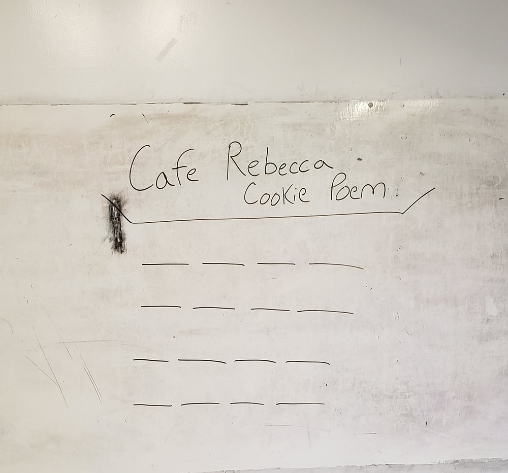 School white board set up with sixteen blank, black lines in a four by four grid.